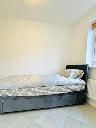 a bed in a room with a wall at Best Places to Stay in Kent in Kent