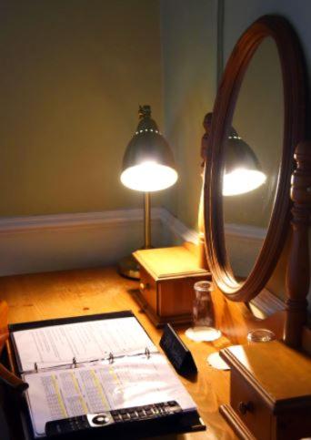 a desk with a laptop and a mirror and a lamp at The Old Bank Bruff Family Town House in Bruff