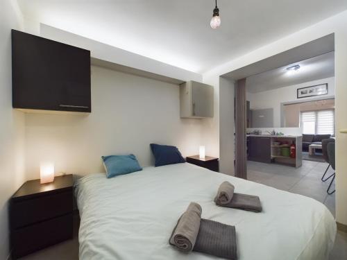 a bedroom with a large bed with two pairs of socks on it at Chez Mémé in La Roche-en-Ardenne