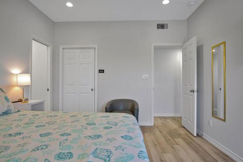a bedroom with a bed and a desk and a chair at Spacious Beachfront 5BR with Gorgeous Ocean views - Blue Footed in Bolivar Peninsula