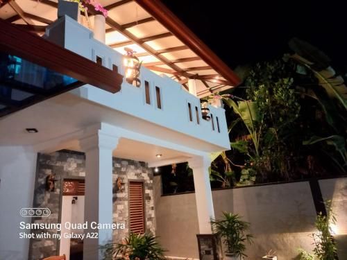 a white house with a staircase in front of it at Villa Meghana in Galle