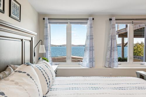 a bedroom with a bed and a view of the water at Lakeshore Vermont in Colchester