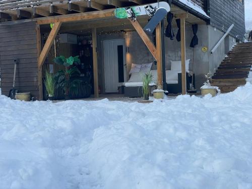 a pile of snow in front of a house at Bingo apartaments in Hønefoss