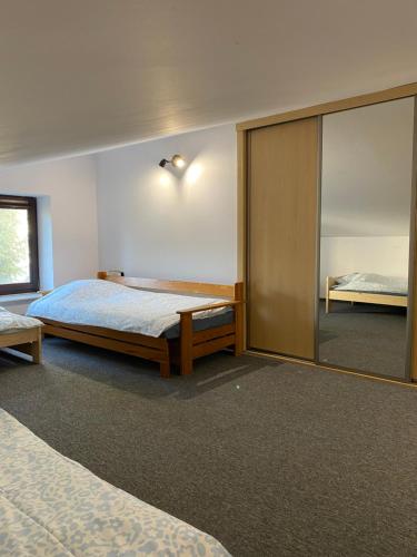 a bedroom with two beds and a large mirror at Marki hostel in Marki