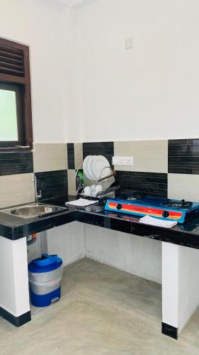 a kitchen with a counter with a stove top at Sunset Villa in Unawatuna