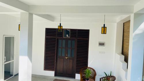 a hallway with a wooden door in a house at Sunset Villa in Unawatuna