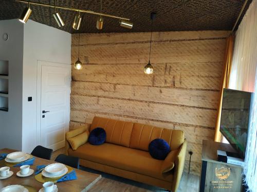 a living room with a couch and a table at "Nad Zdrojami" Pokoje Kowalczyk in Szczawnica