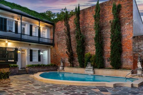 a swimming pool in front of a brick building at Chateau Hotel in New Orleans