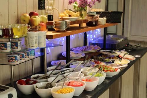 a buffet with many bowls of food on a table at Ustronie in Karpacz
