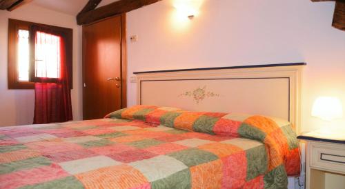 a bedroom with a bed with a colorful blanket at Best Holidays Venice in Venice