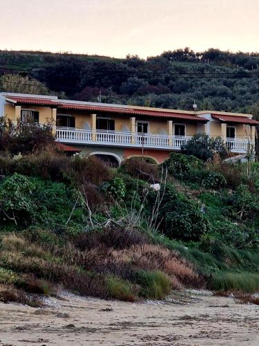 a house on top of a hill next to a river at Seasound in Agios Stefanos