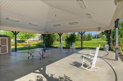 a large covered patio with a table and chairs at The Marmot - 12 Butternut in Cherry Valley