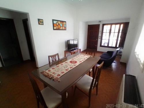 a dining room with a table and chairs at house city in Mar del Plata