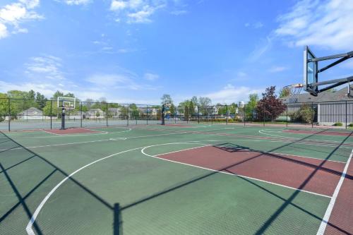 a tennis court with two tennis courts at The Jackrabbit - 3 Summer Village in Cherry Valley