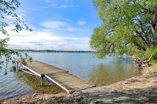 a wooden dock sitting on the side of a lake at The Jackrabbit - 3 Summer Village in Cherry Valley