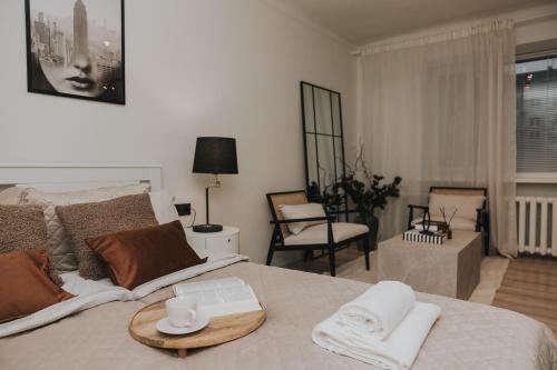 a bedroom with a bed with a table on it at Lacplesa Street Apartment in Daugavpils