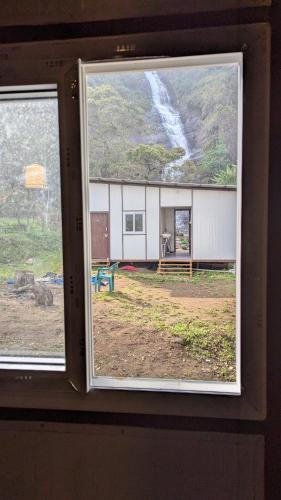 a view of a building from a window at Campia Homestay Kookal in Kodaikānāl