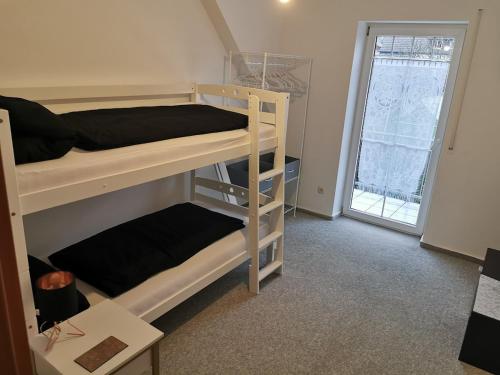 a room with two bunk beds and a window at Lounge house in Burgau