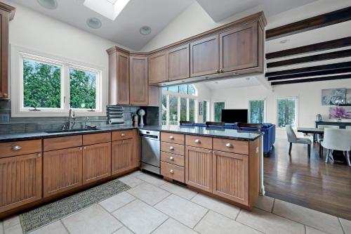 a large kitchen with wooden cabinets and a dining room at Lake Shore Living in Michiana