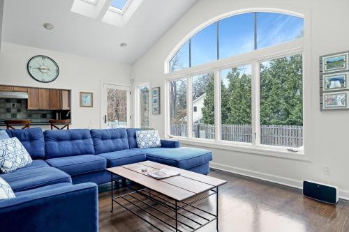 a living room with a blue couch and a table at Lake Shore Living in Michiana