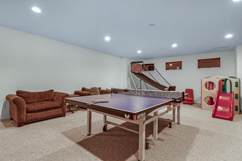 a living room with a ping pong table in it at Lake Shore Living in Michiana