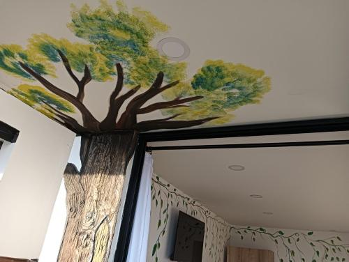 a painting of a tree on the ceiling of a room at VIVE PARADISE Hosteria Termal Mirador Only Adult in Medellín