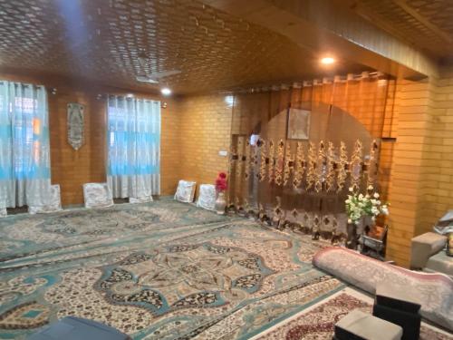 a room with a large rug in a room with a synagogue at Visiting Villa in Srinagar