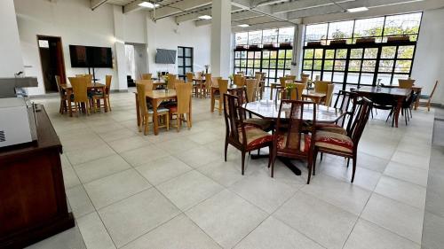 a dining room with tables and chairs in a restaurant at Hotel San Pedro del Fuerte in Medellín
