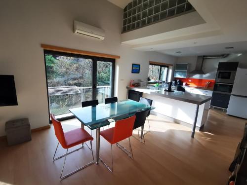 a kitchen with a blue table and some chairs at Casa da Ponte in Troporiz