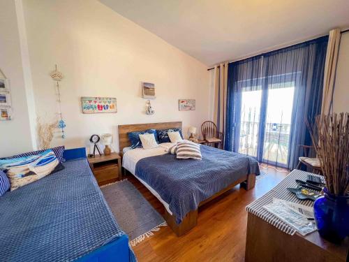 a bedroom with a bed and a couch at Apartments Panorama in Senj
