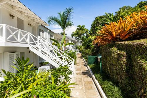 a stairway leading up to a house with plants at Round Hill Hotel & Villas in Montego Bay