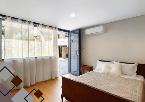 a bedroom with a bed and a sliding glass door at Quinta de Ramil in Vieira do Minho
