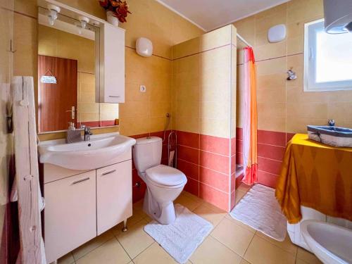 a bathroom with a toilet and a sink at Apartments Panorama in Senj