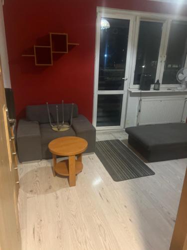 a living room with a couch and a table at Kwatery pracownicze Rumia in Rumia