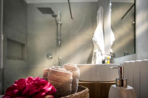 - Baño con lavabo y cesta de toallas en Dimora Torremuzza en Palermo
