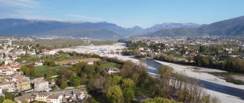a town with a river and mountains in the background at B&B Terre Di Bea in Pederobba