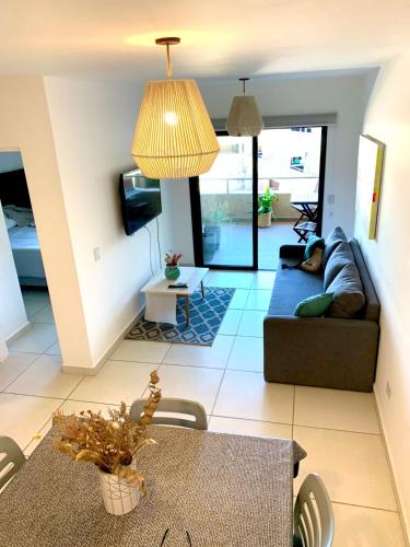 a living room with a couch and a table at Allende Apart NG in Villa Allende