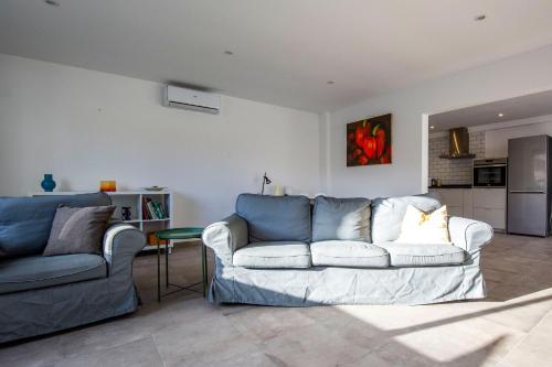 a living room with a couch and a kitchen at Open and large 1 bed apartment in L'Alfas del Pi