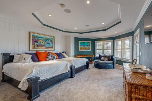 a bedroom with a bed and a chair in it at The Chancellery --- 6 Hall Ave in Dewey Beach
