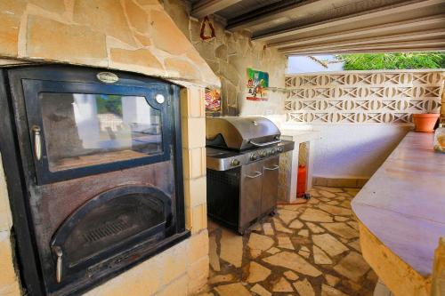 a stone kitchen with a stove and a counter at Open and large 1 bed apartment in L'Alfas del Pi