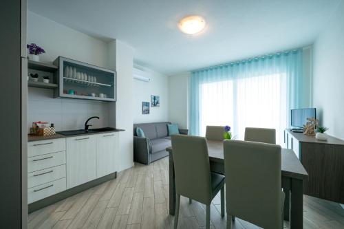 a kitchen and dining room with a table and chairs at Milena Suite Apartments in Alghero