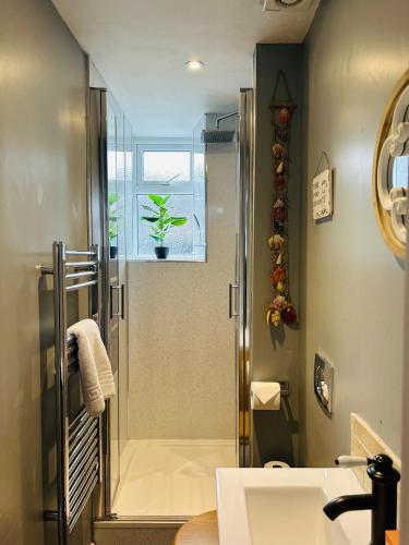 a bathroom with a shower and a sink at The Old Post Office - MaisonPro in Stroud
