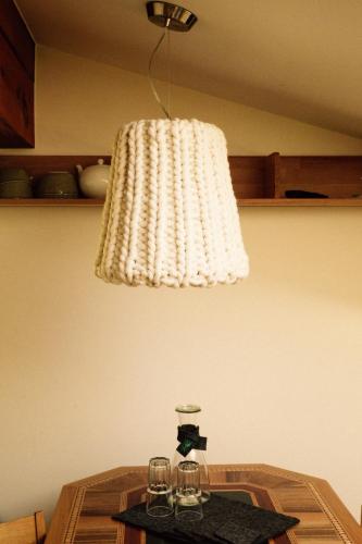a light hanging over a table with glasses on it at Tanafreida Berg-Refugium in Sankt Gallenkirch