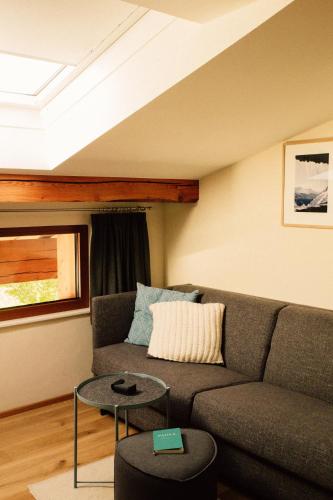 a living room with a couch and a table at Tanafreida Berg-Refugium in Sankt Gallenkirch