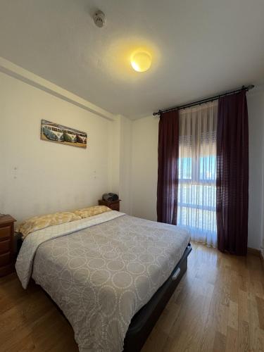 a bedroom with a large bed and a window at Casa con piscina in Madrid