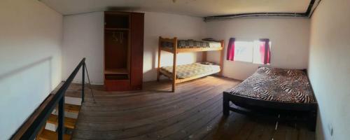 a room with a staircase and a bed in a room at Departamentos Lovaiza`s in Barrio Félix U Camet