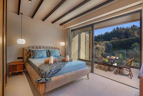 a bedroom with a bed and a large window at Vadis Luxury Villa Rhodes in Koskinou