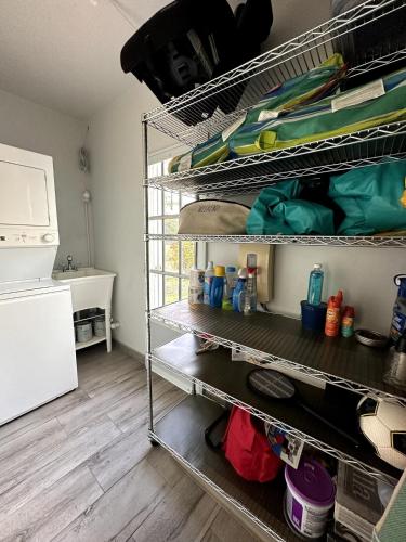 a kitchen with metal shelves in a room at Villatoña, 4BR, Beach house with pool in Aguada