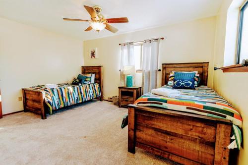 a bedroom with two beds and a ceiling fan at The CubHouse Poconos getaway in Tobyhanna
