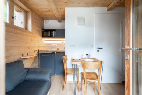 a small kitchen and dining room with a table and chairs at La ferme d'Hauteluce - Chalets in Hauteluce